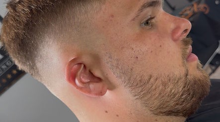 Modern hairstyle at Beau Brims, Copthorne, England, GB showcasing a clean fade cut.