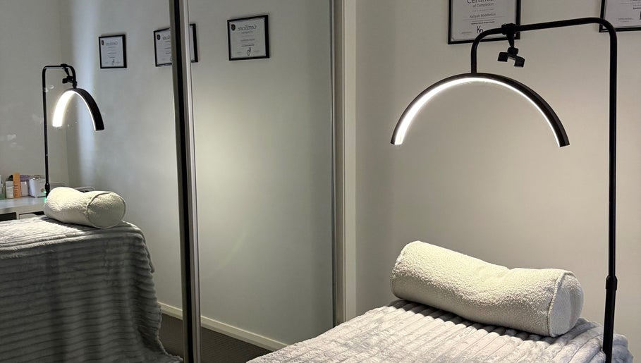 Tranquil treatment room at Latenight_brows, Airds, New South Wales, AU with a plush bed and modern lighting.