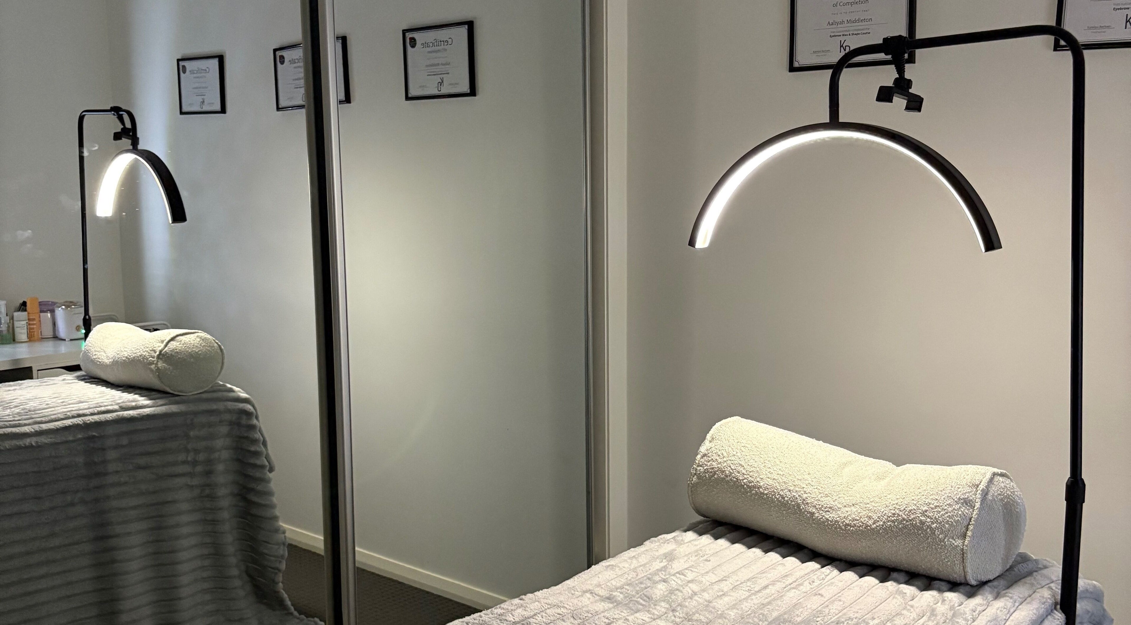 Latenight Brows spa room in Airds, New South Wales, AU, featuring a cozy treatment bed and soft lighting.
