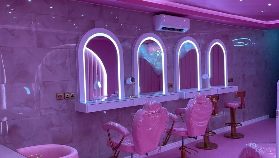 Luxurious pink beauty salon interior at byhollymay, Conisbrough, England, GB with elegant mirrors and seating.