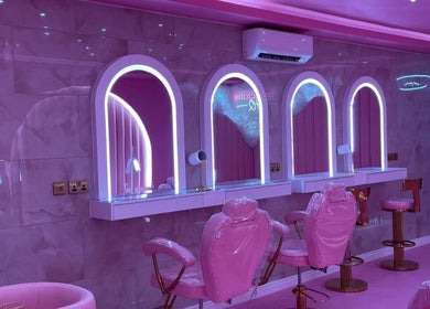 Luxurious pink beauty salon interior at byhollymay, Conisbrough, England, GB with elegant mirrors and seating.