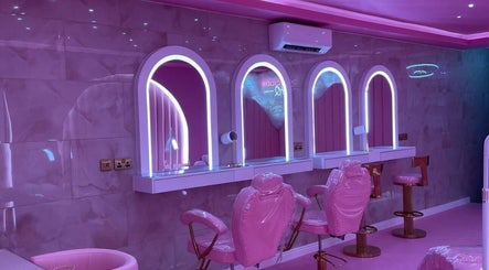 Luxurious pink beauty salon interior at byhollymay, Conisbrough, England, GB with elegant mirrors and seating.