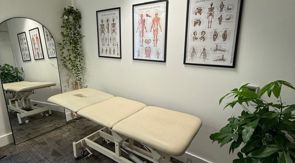 Calming treatment room at The Body Formulae, London, England, GB, with anatomy posters and greenery.