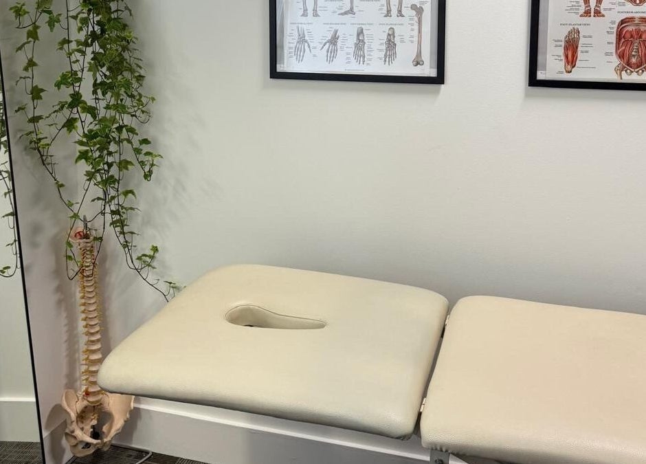 Treatment room at The Body Formulae in London, England, GB with massage table and anatomy posters.