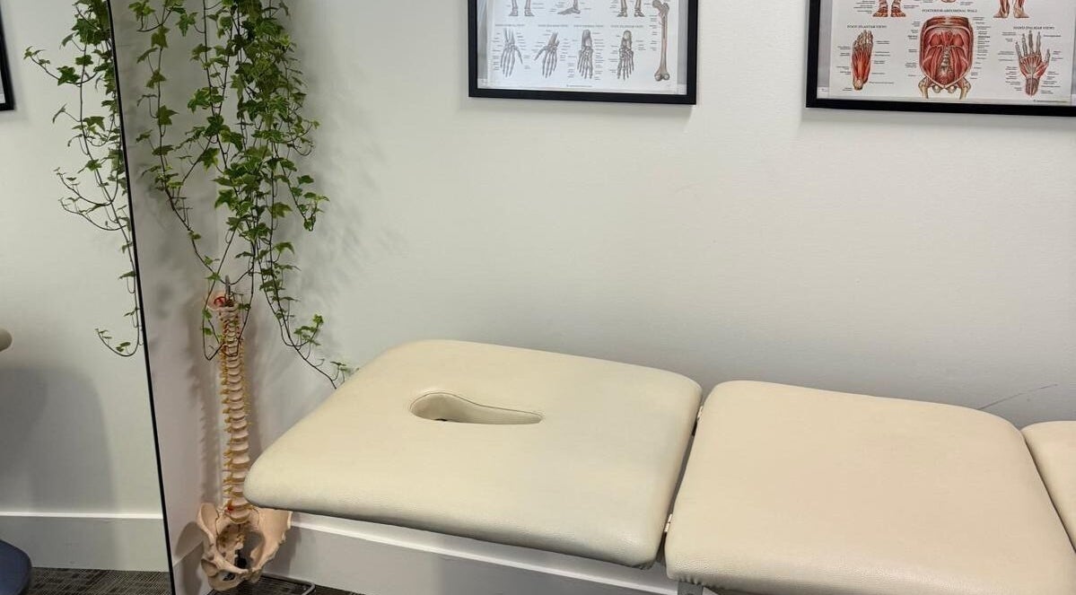 Treatment room at The Body Formulae in London, England, GB with massage table and anatomy posters.