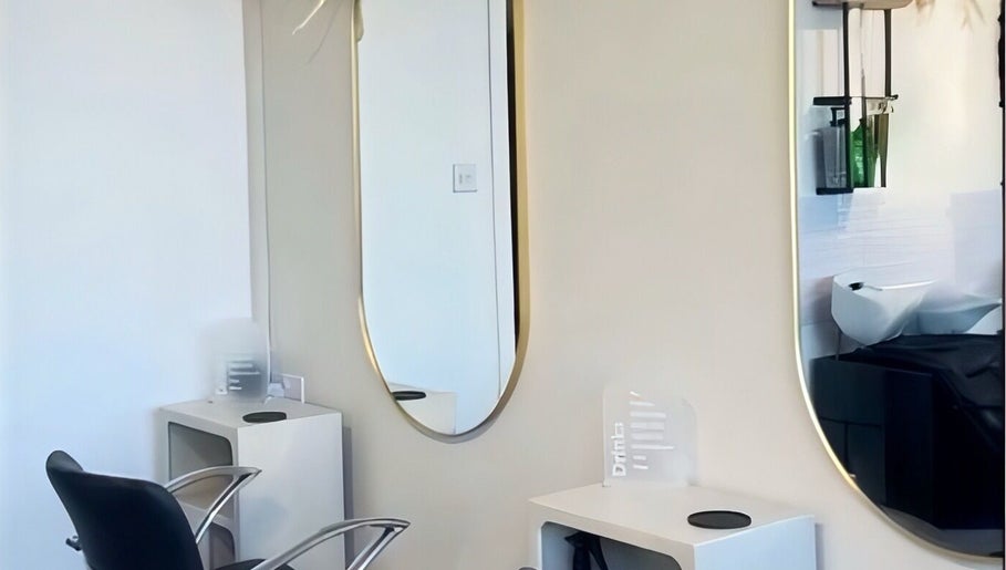 Elegant salon station at HairByMadi, Bradford, England, GB showcasing modern styling chairs and mirrors.