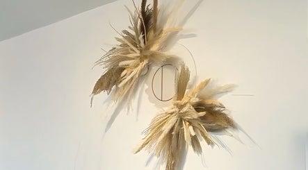 Chic dried floral decor at HairByMadi in Bradford, England, GB elevates the salon's serene aesthetic.