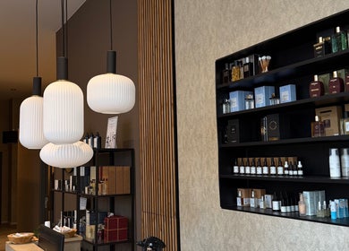 Chic product display at Cmj Health Care & Beauty, Bruxelles, Bruxelles, BE, with modern hanging lights.