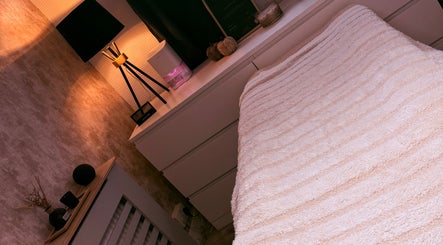 Relaxing ambiance at Aura Studio, Thornton-cleveleys, England, with a neatly arranged spa bed.