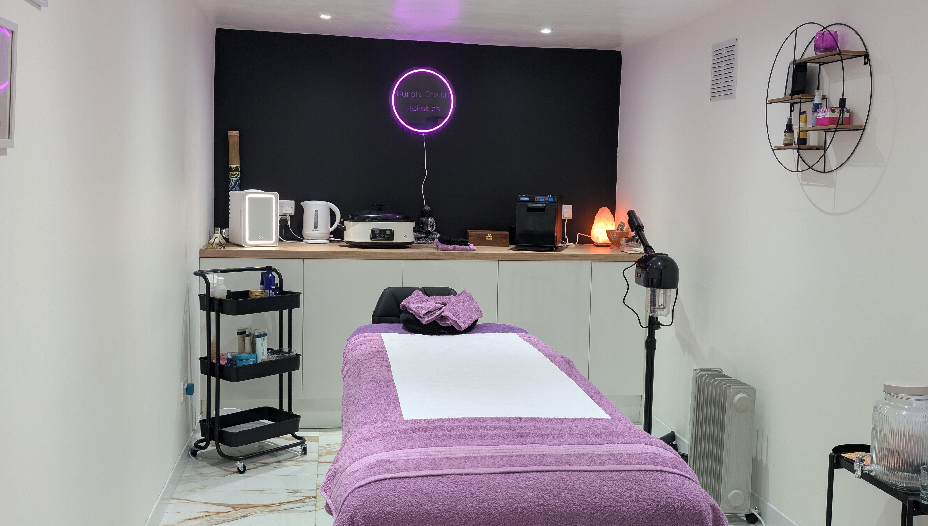 Therapy room at Purple Crown Holistics, Eston, England, GB, with a cozy bed and relaxing ambiance.