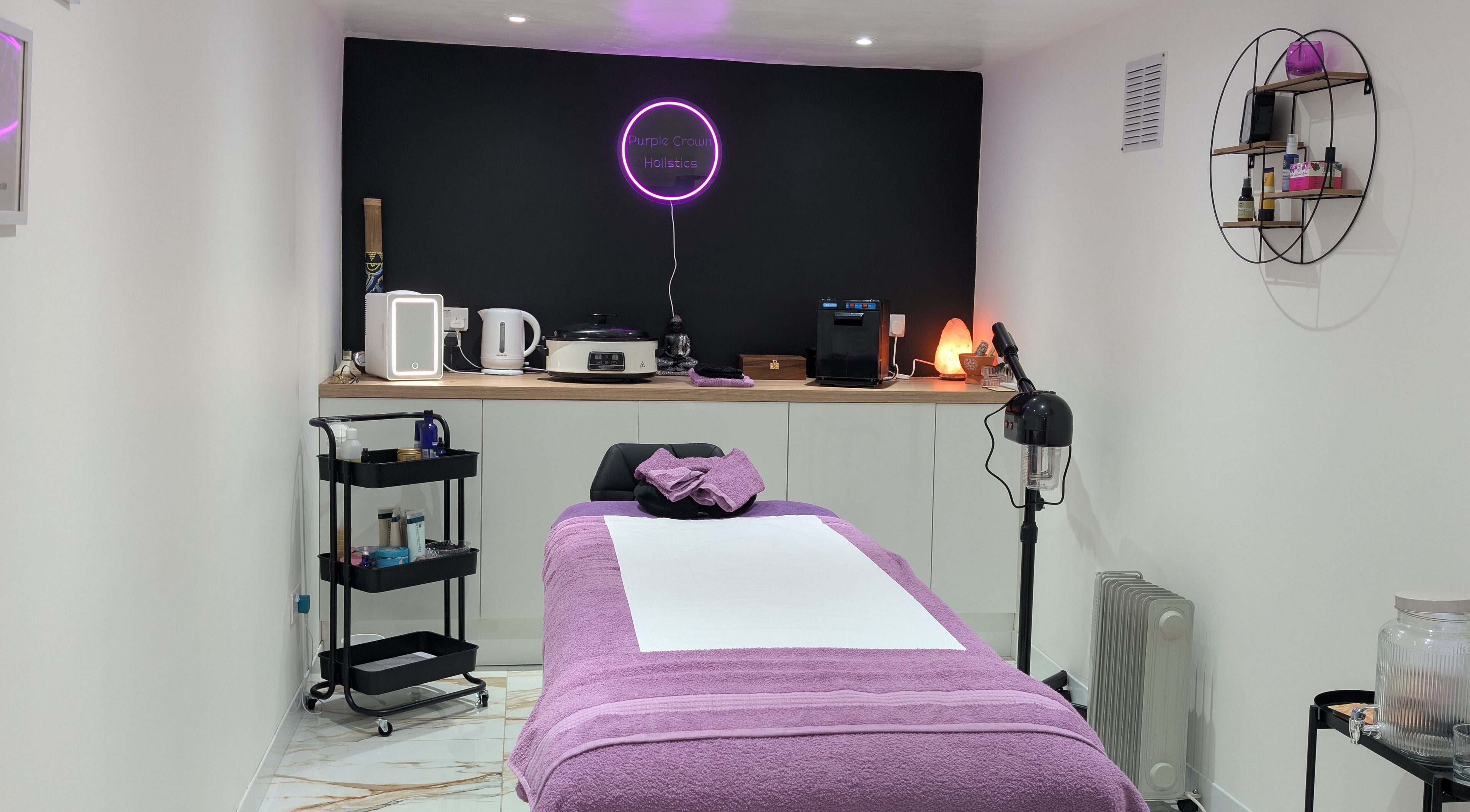 Therapy room at Purple Crown Holistics, Eston, England, GB, with a cozy bed and relaxing ambiance.