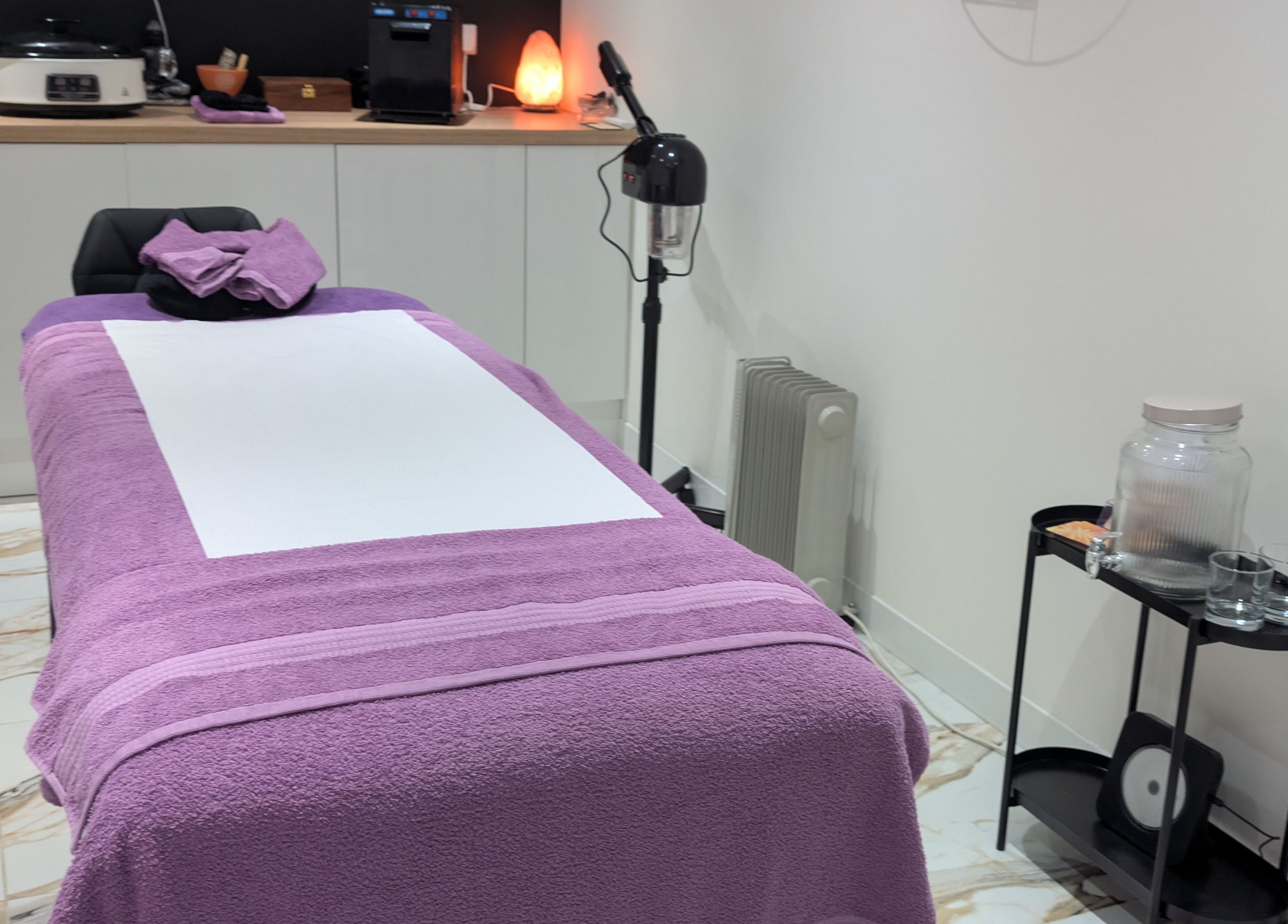 Calming treatment room at Purple Crown Holistics, Eston, England, GB with a lavender massage table.