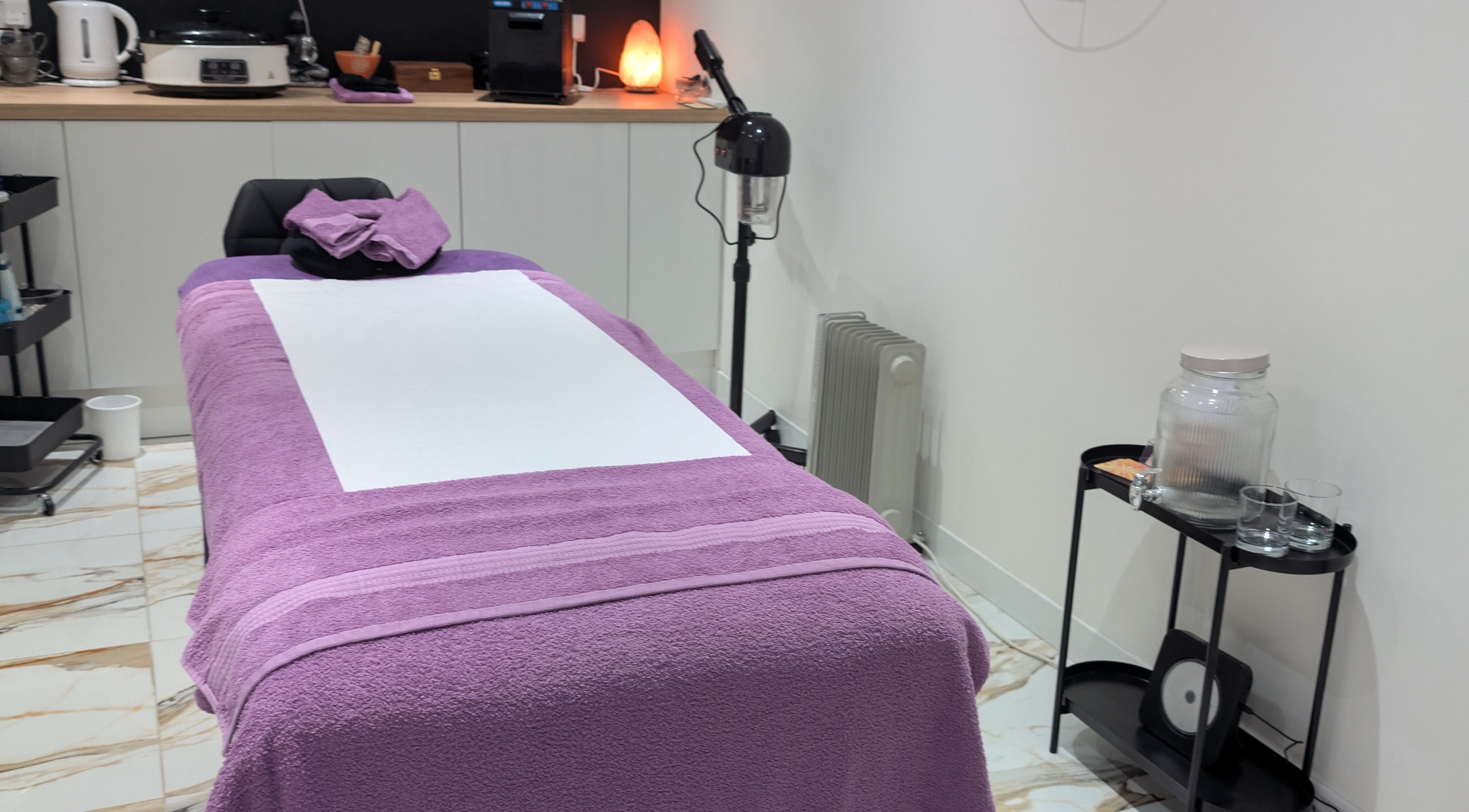 Calming treatment room at Purple Crown Holistics, Eston, England, GB with a lavender massage table.