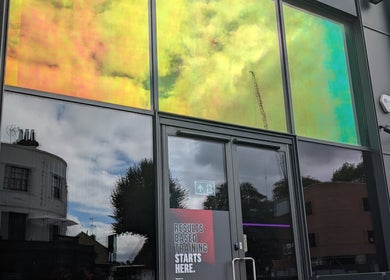 Colorful facade of Axiom Nature in London, England, GB, reflecting the city skyline.