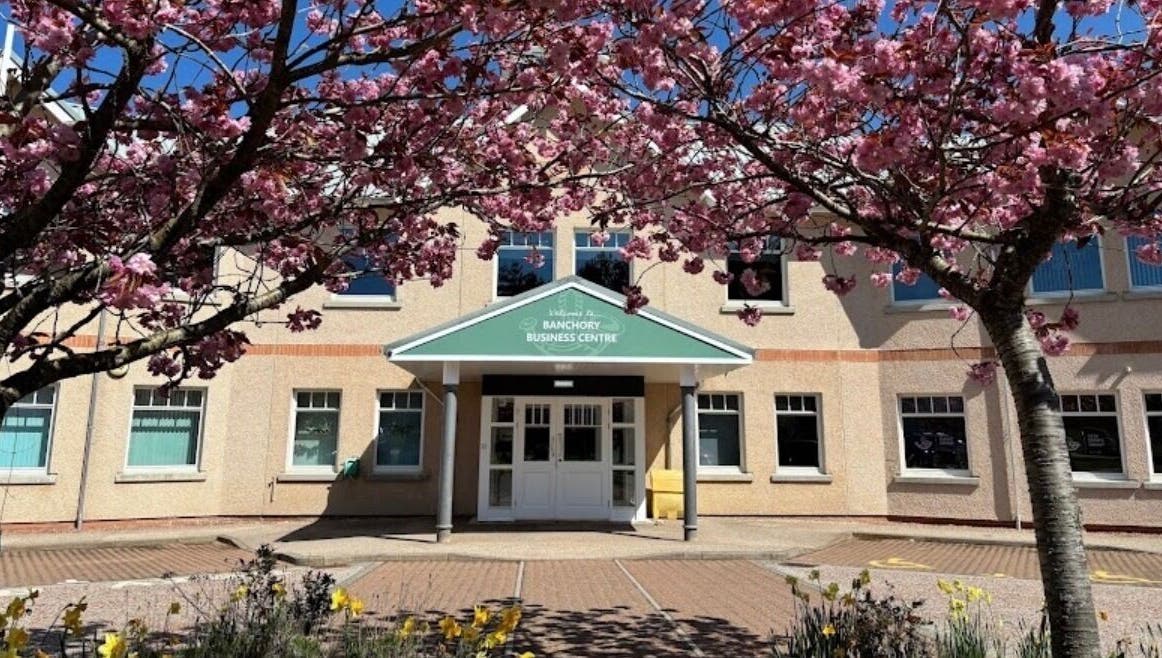 Entrance to Hair by Gillian Edmonstone framed by cherry blossoms, located in Banchory, Scotland, GB.