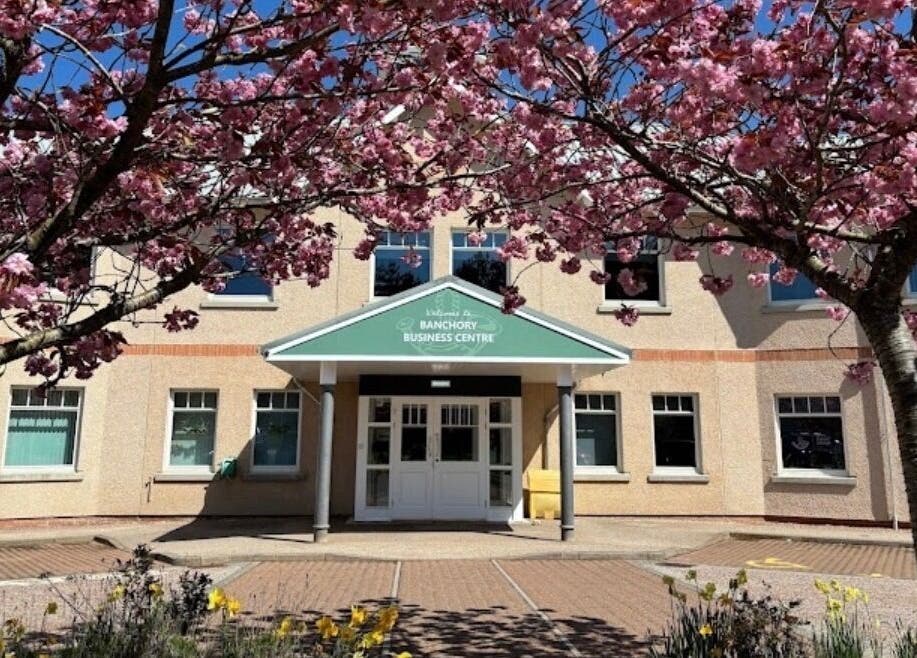 Entrance to Hair by Gillian Edmonstone framed by cherry blossoms, located in Banchory, Scotland, GB.