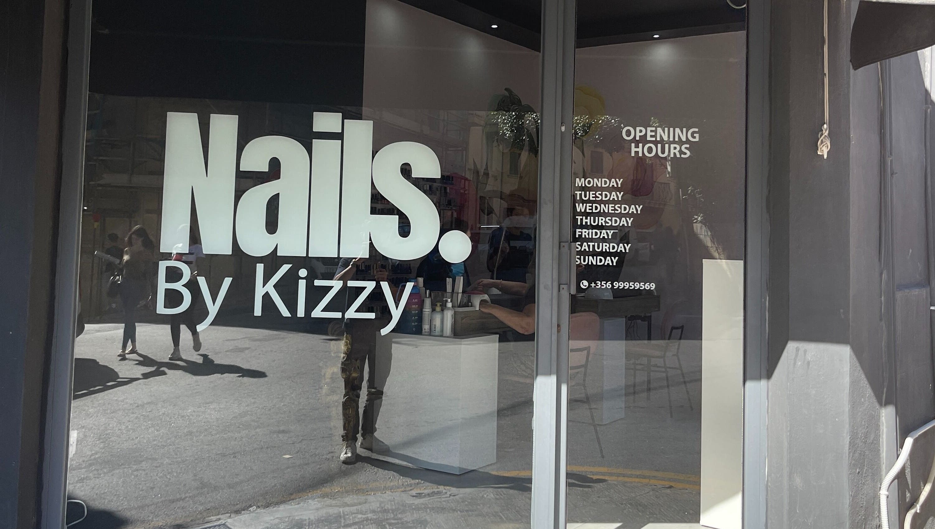 Nails by Kizzy, Tas-sliema, MT showcases its modern entrance with bold signage and opening hours.