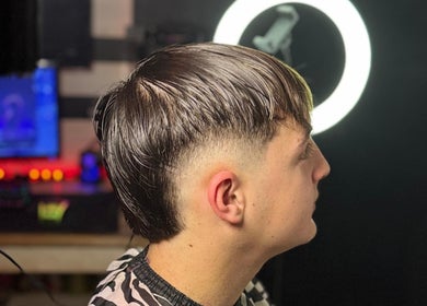 Stylish haircut at Delpa Barber, Arroyo Seco, Santa Fe, AR showing side profile with modern design.