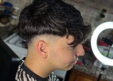 Modern fade haircut at Delpa Barber, Arroyo Seco, Santa Fe, AR. Side view of a man's stylish haircut.