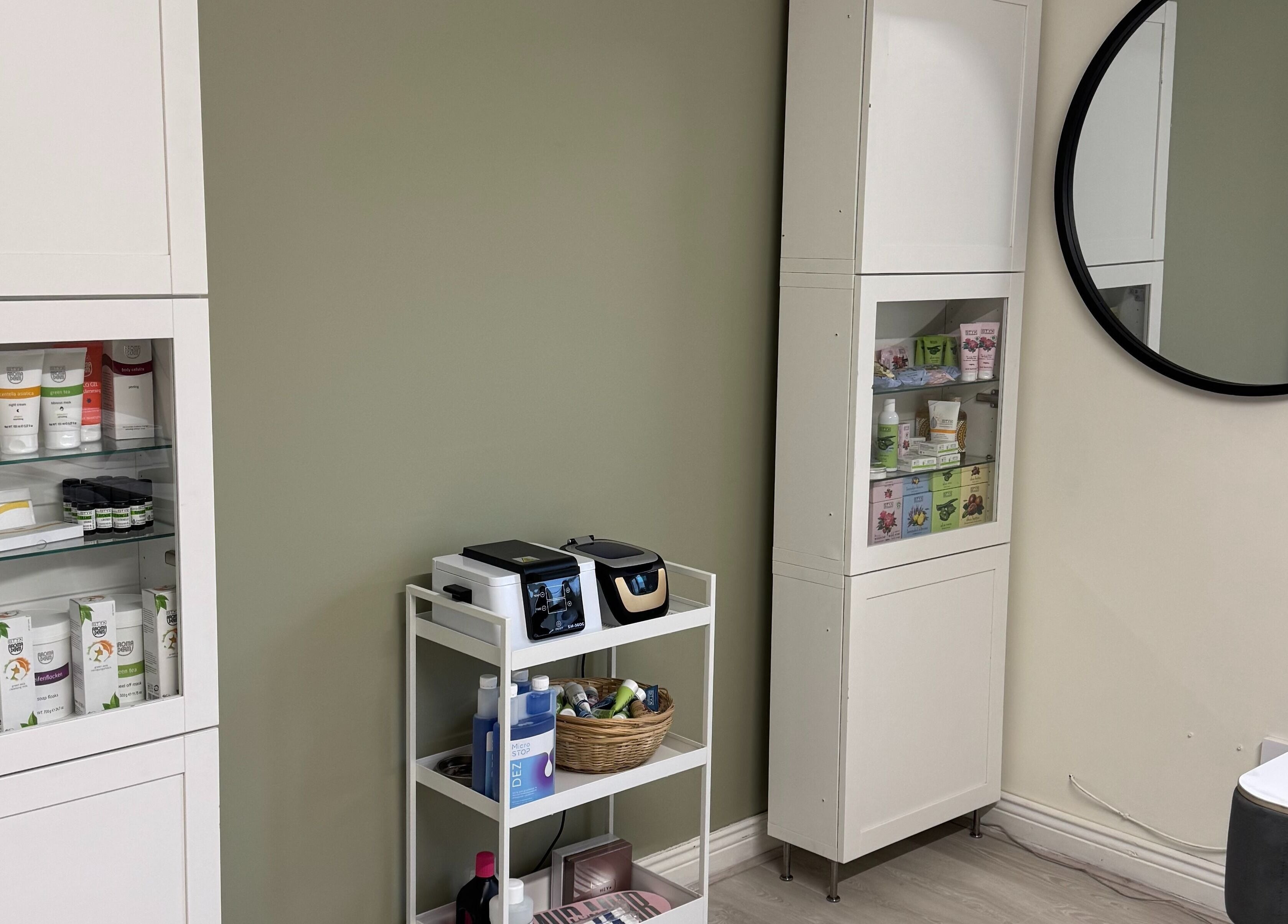 Product shelves and a round mirror at Solais Beauty Studio, Ratoath, IE, displaying skincare and wellness items.