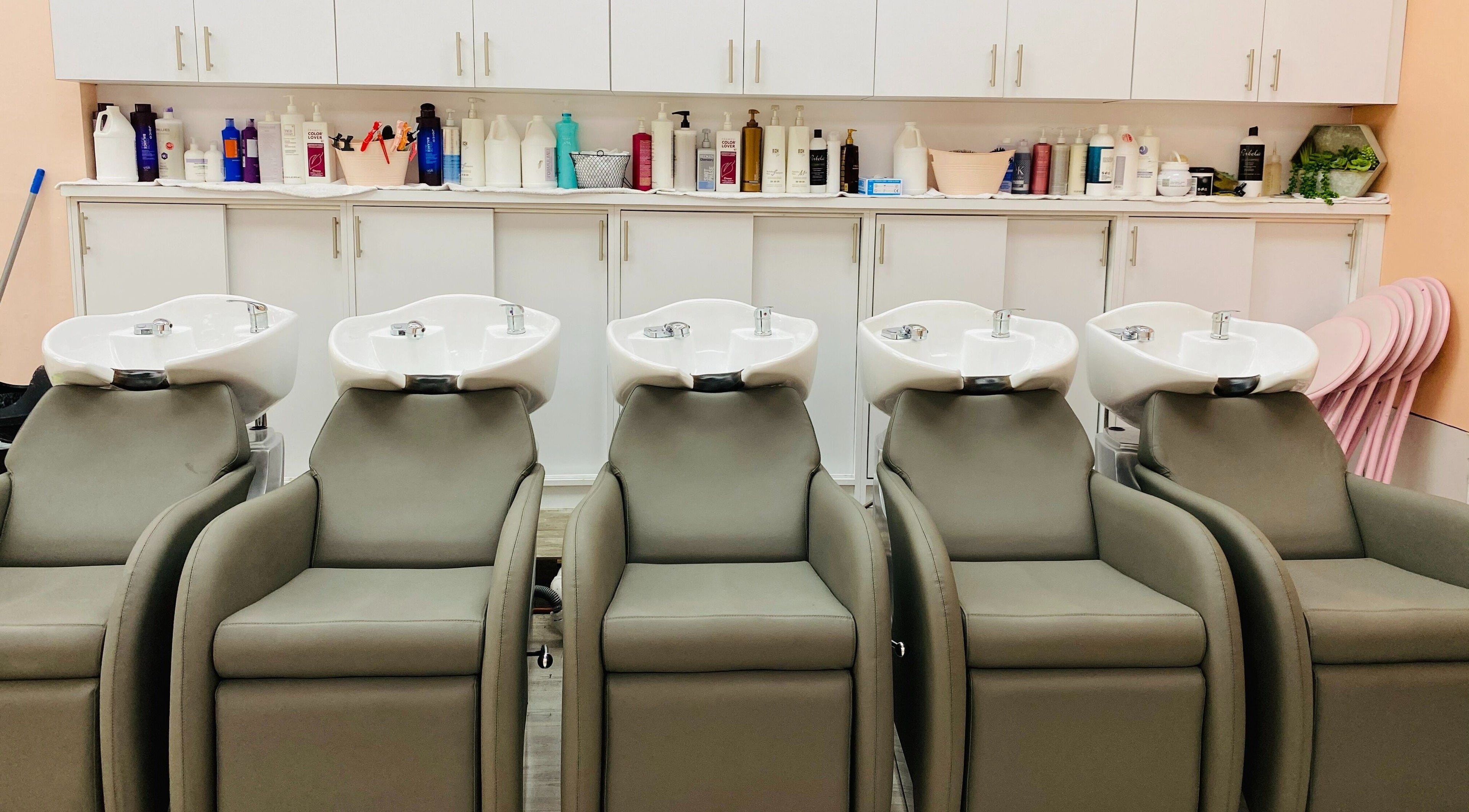 Modern shampoo stations at Millenial Beauty Salon - Kendall, Miami, Florida, US, lined up neatly for clients.