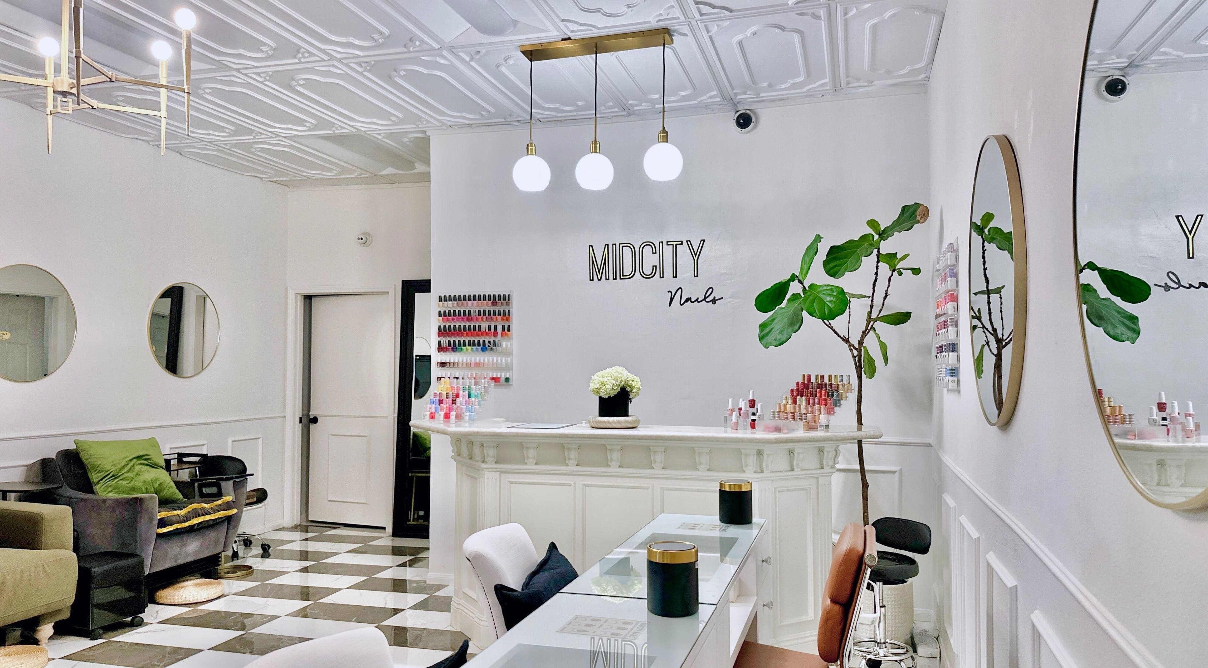 Stylish interior of Mid City Nails salon in Los Angeles, California, US featuring elegant decor and polish display.