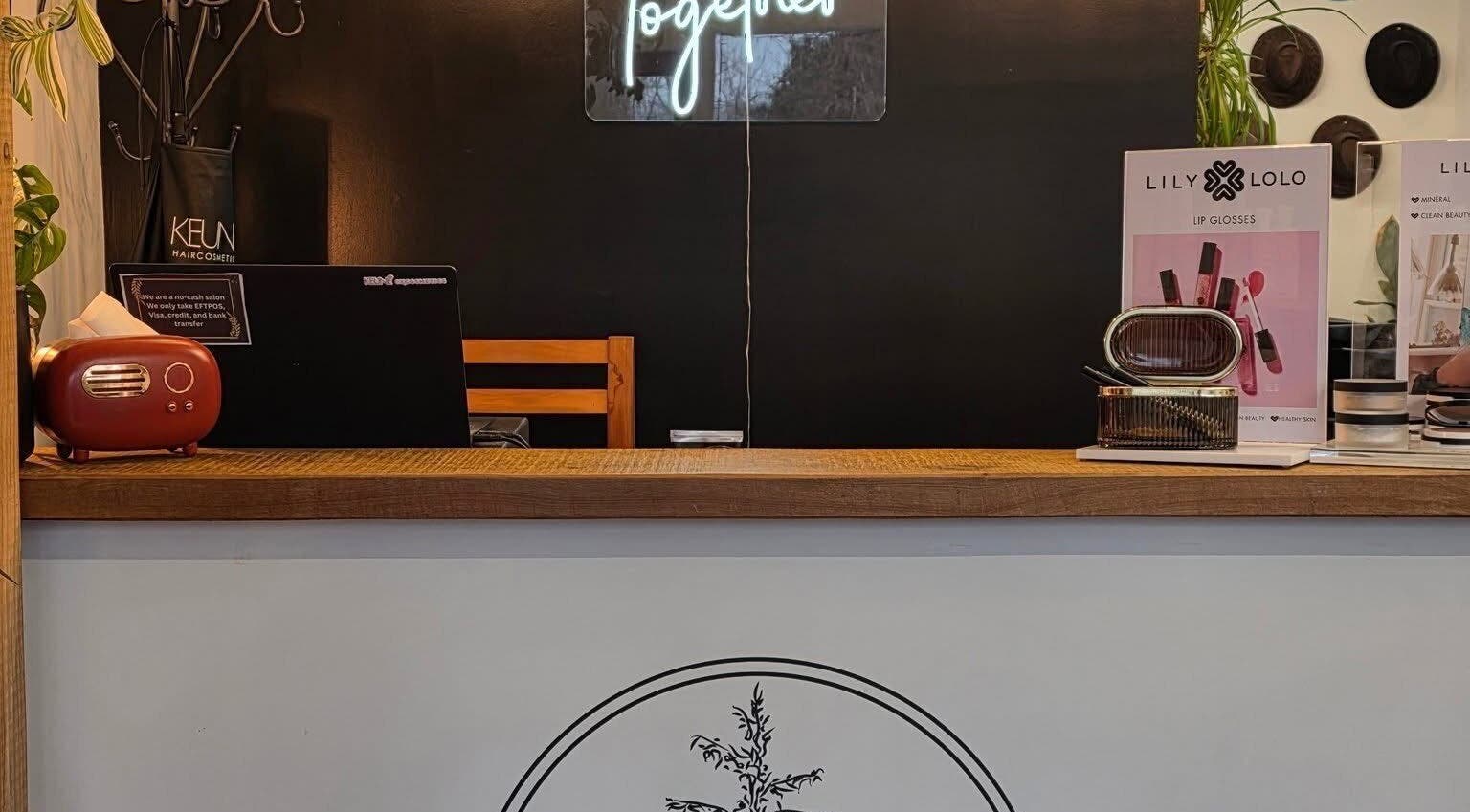 Stylish reception at Cedar Heights hair studio, Cust, Canterbury Region, NZ, featuring a modern counter and decor.