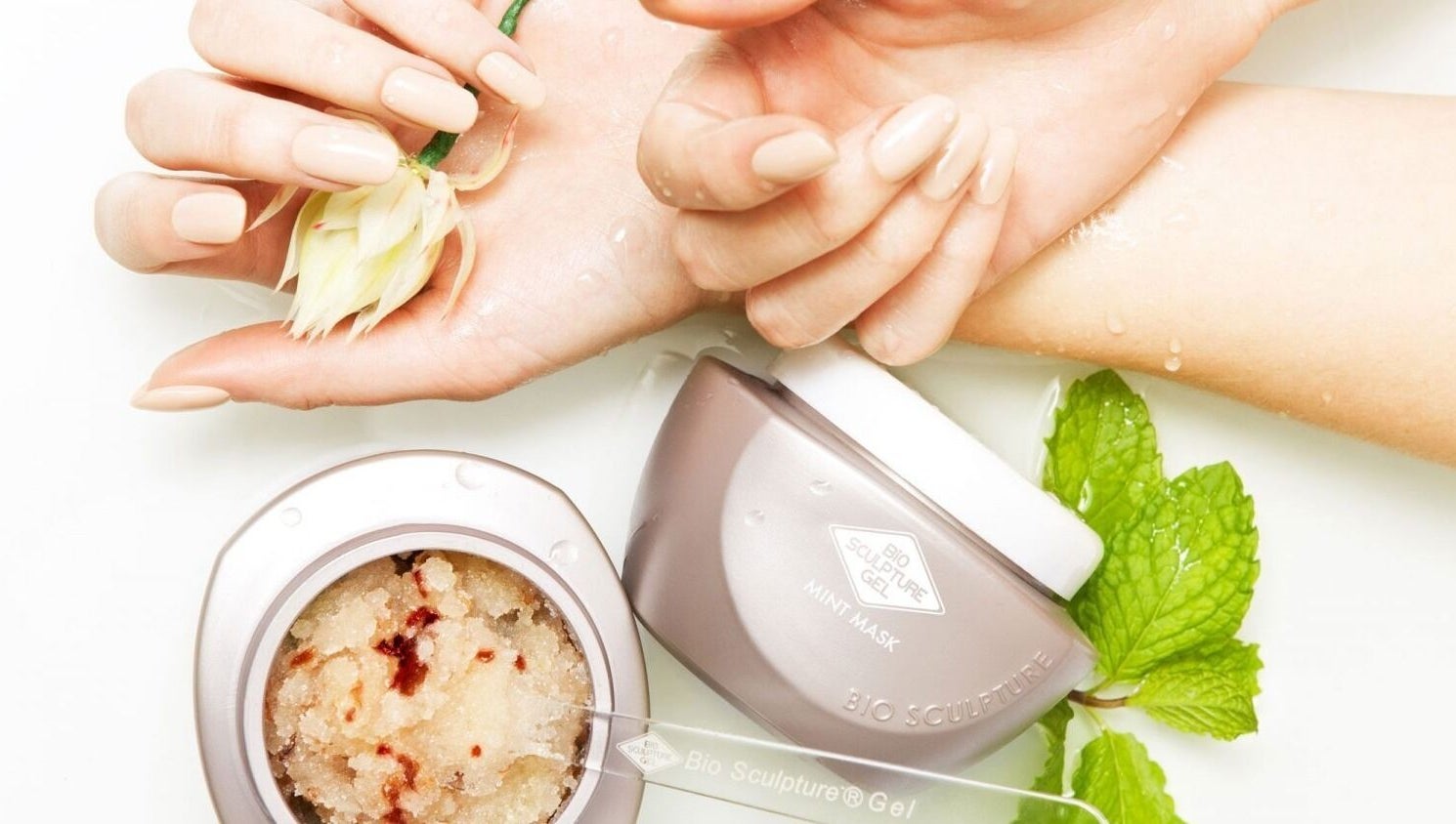 Luxurious hand treatment at Nicky's Beauty, Pretoria, Gauteng, ZA featuring soothing mint mask and floral touch.