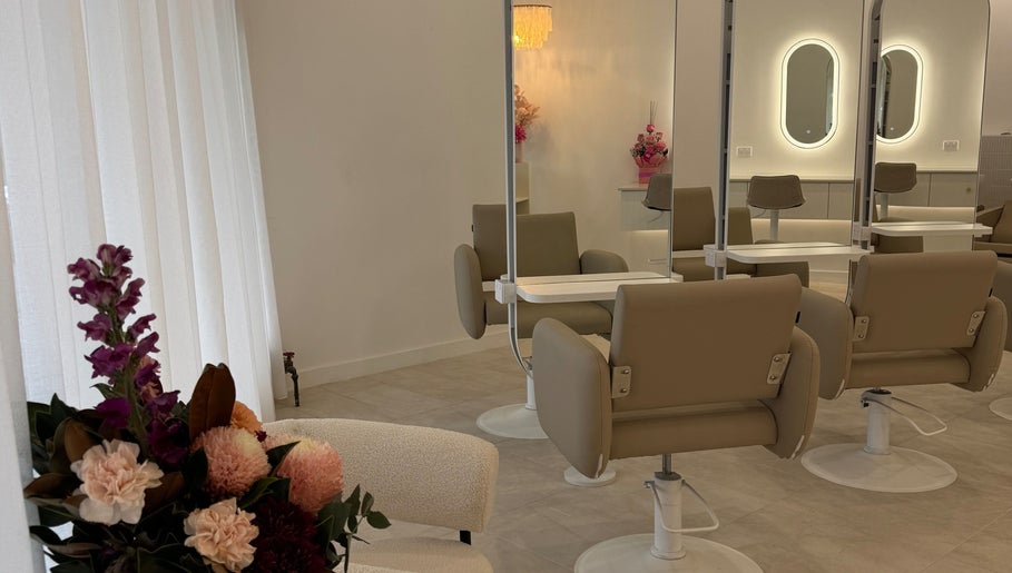 Elegant interior of Haute Hair By Shelbie-Marie, Melbourne, Victoria with stylish chairs and flower decor.