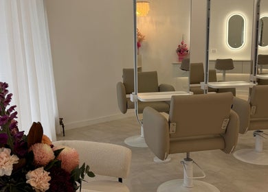 Elegant interior of Haute Hair By Shelbie-Marie, Melbourne, Victoria with stylish chairs and flower decor.