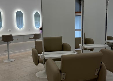 Modern salon interior at Haute Hair By Shelbie-Marie, Melbourne, Victoria, AU featuring sleek chairs and mirrors.