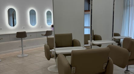 Modern salon interior at Haute Hair By Shelbie-Marie, Melbourne, Victoria, AU featuring sleek chairs and mirrors.