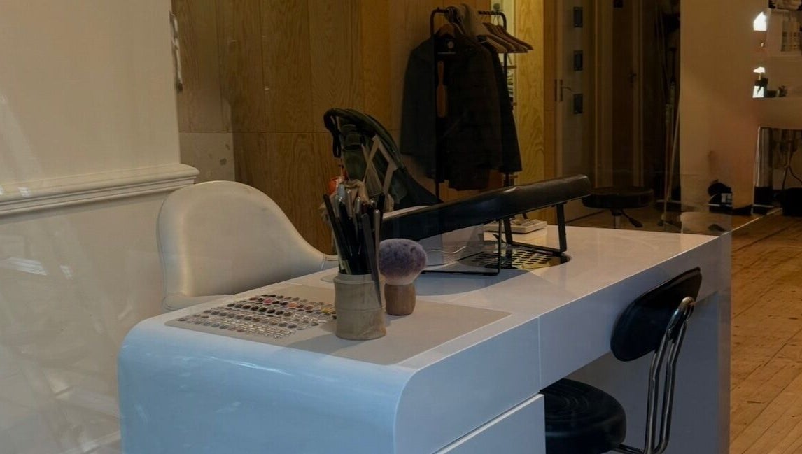 Elegant nail station at Lino, London, England, GB, featuring a modern white table and plush chair.