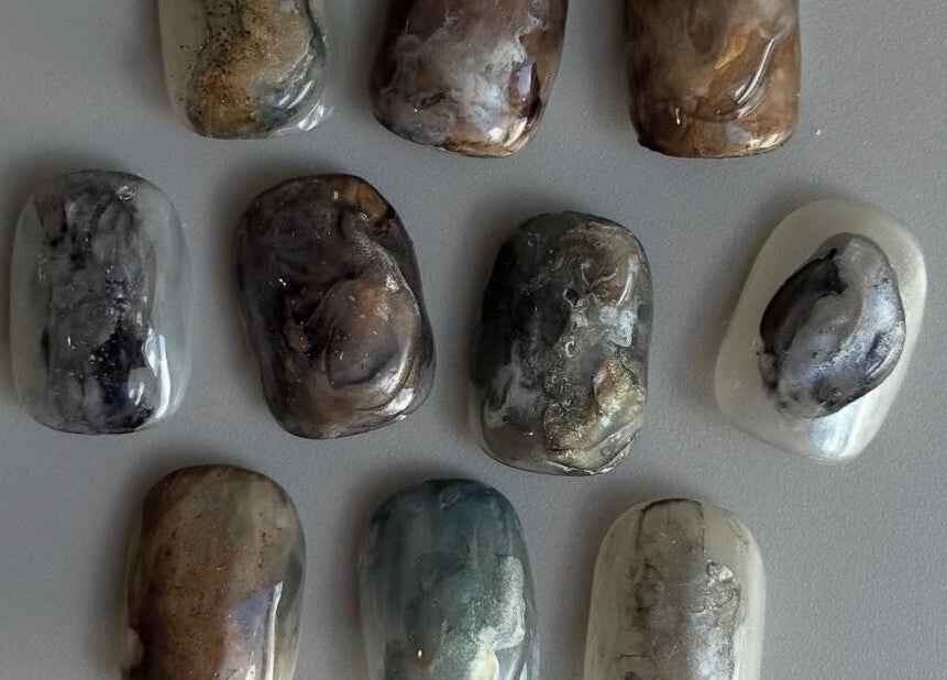 Collection of marble-style nail designs at Lino, London, England, GB, showcasing unique patterns.