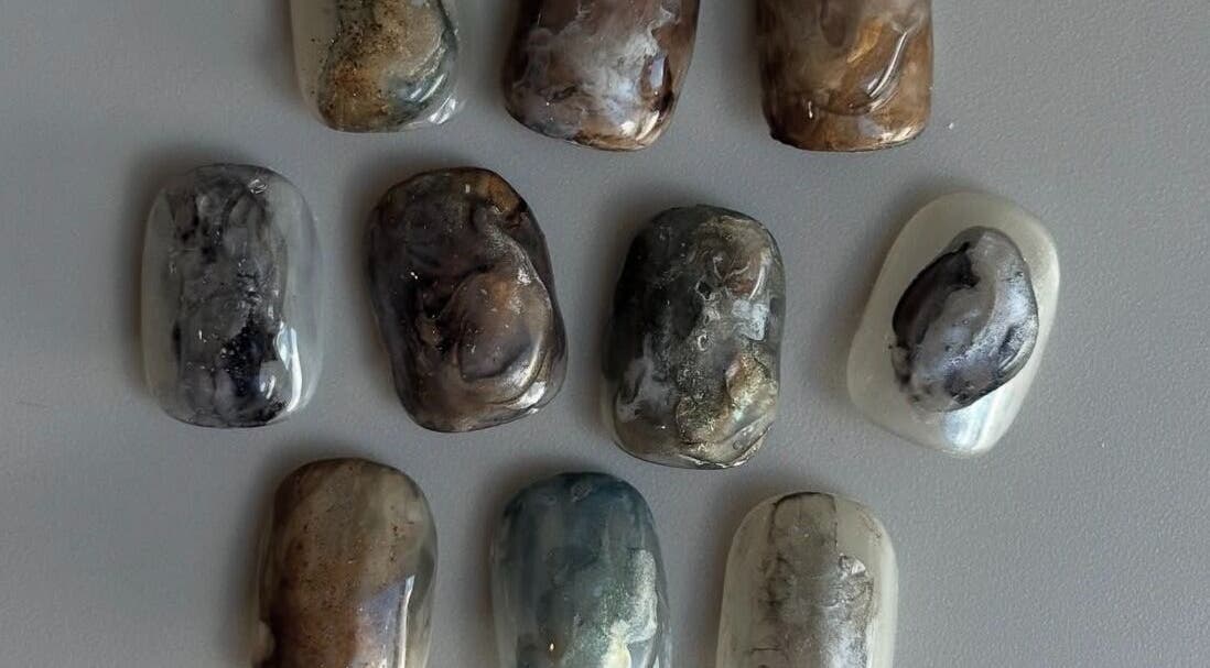 Collection of marble-style nail designs at Lino, London, England, GB, showcasing unique patterns.