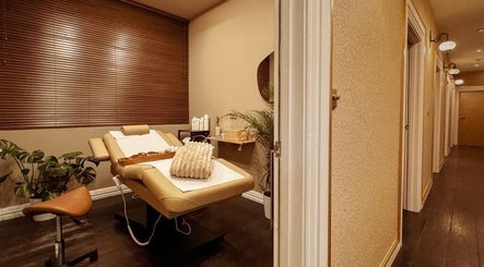 Relaxing treatment room at Therapy by aq, Birmingham, England, GB with a comfortable massage bed and calming decor.