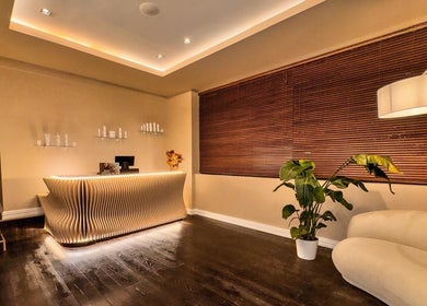 Elegant spa reception at Therapy by aq in Birmingham, England, GB with cozy lighting and modern design.