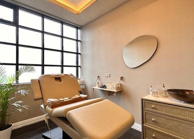 Relaxing therapy room at Therapy by aq, Birmingham, England, GB, featuring a plush treatment bed and tranquil decor.