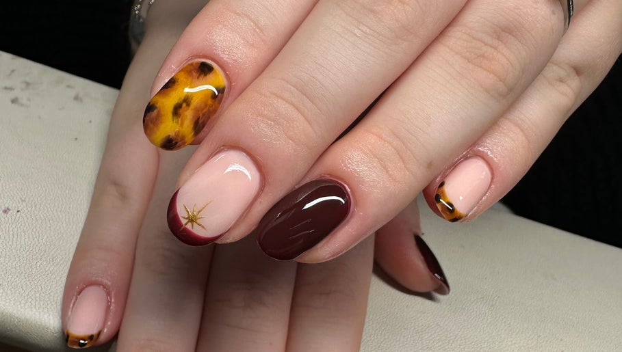 Stylish nail design at Nailchemi Beauty in Milton Keynes, England, GB, featuring unique colors and patterns.