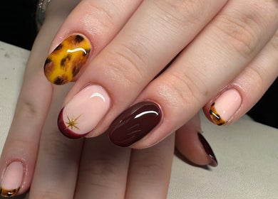 Stylish nail design at Nailchemi Beauty in Milton Keynes, England, GB, featuring unique colors and patterns.
