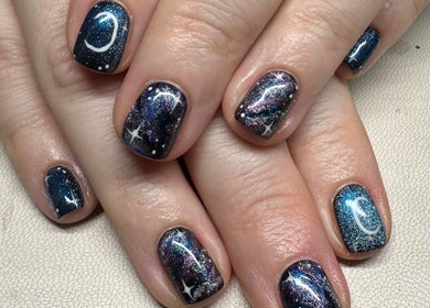 Galaxy-inspired nail art at Nailchemi Beauty, Milton Keynes, England, GB. Shimmering cosmic designs on manicured nails.