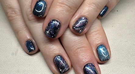 Galaxy-inspired nail art at Nailchemi Beauty, Milton Keynes, England, GB. Shimmering cosmic designs on manicured nails.
