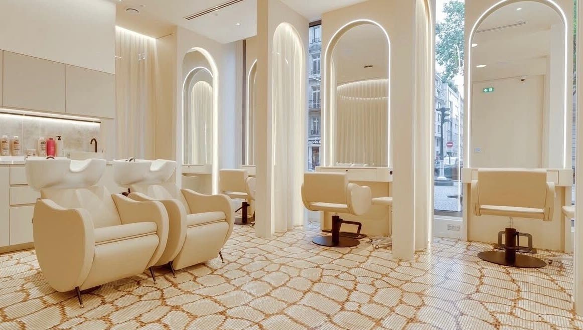 Luxurious salon interior at McKenzie Chun, Paris, Île-de-France, FR with chic styling stations.