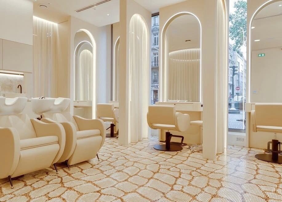 Luxurious salon interior at McKenzie Chun, Paris, Île-de-France, FR with chic styling stations.