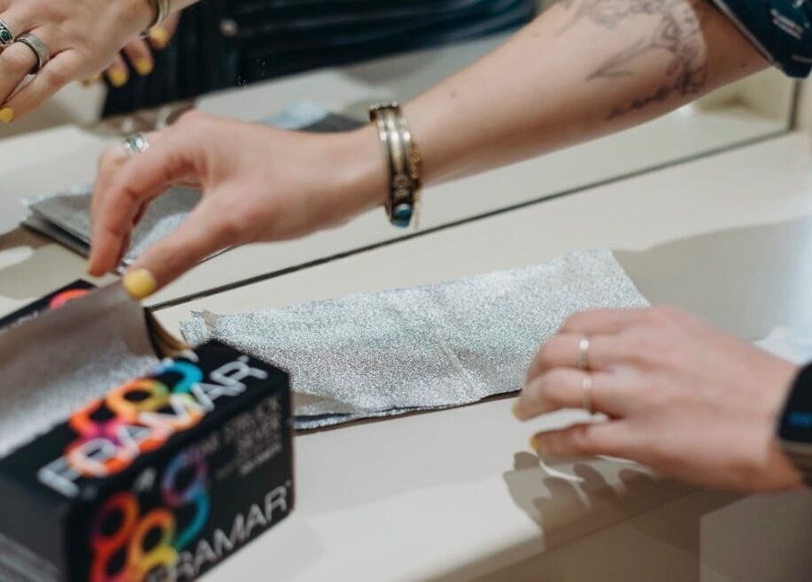 Hands preparing foils at McKenzie Chun, Paris, Île-de-France, FR salon.