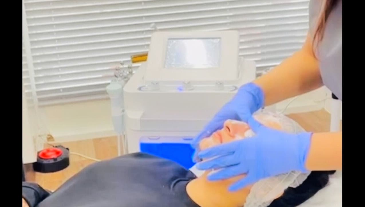 Facial treatment at MGB Aesthetic Clinic, Greater, England, GB, showing a serene client receiving expert care.