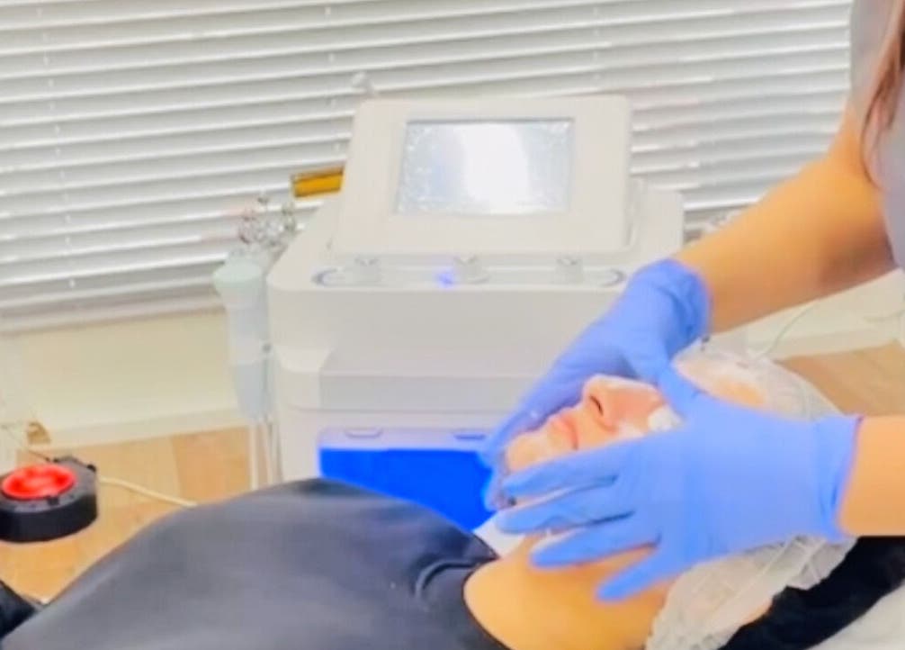 Facial treatment at MGB Aesthetic Clinic, Greater, England, GB, showing a serene client receiving expert care.