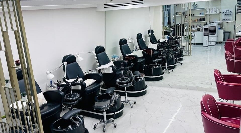 Elegant nail stations at Rolling Nails Dmcc, Dubai, AE, featuring modern chairs and a serene atmosphere.
