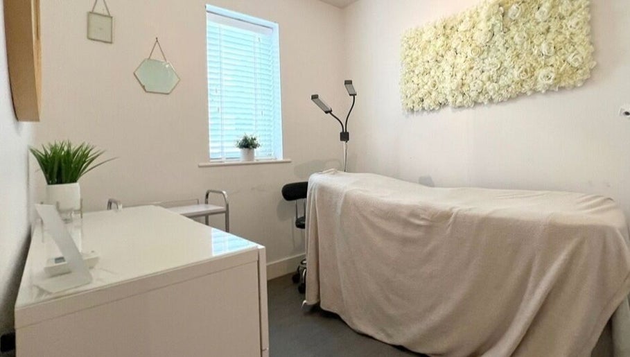 Relaxing treatment room at Lianne Adora Skin & Brows, Holmfirth, England, GB with elegant floral decor.
