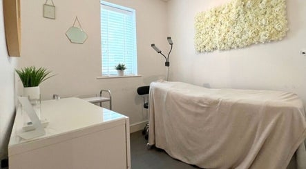 Relaxing treatment room at Lianne Adora Skin & Brows, Holmfirth, England, GB with elegant floral decor.